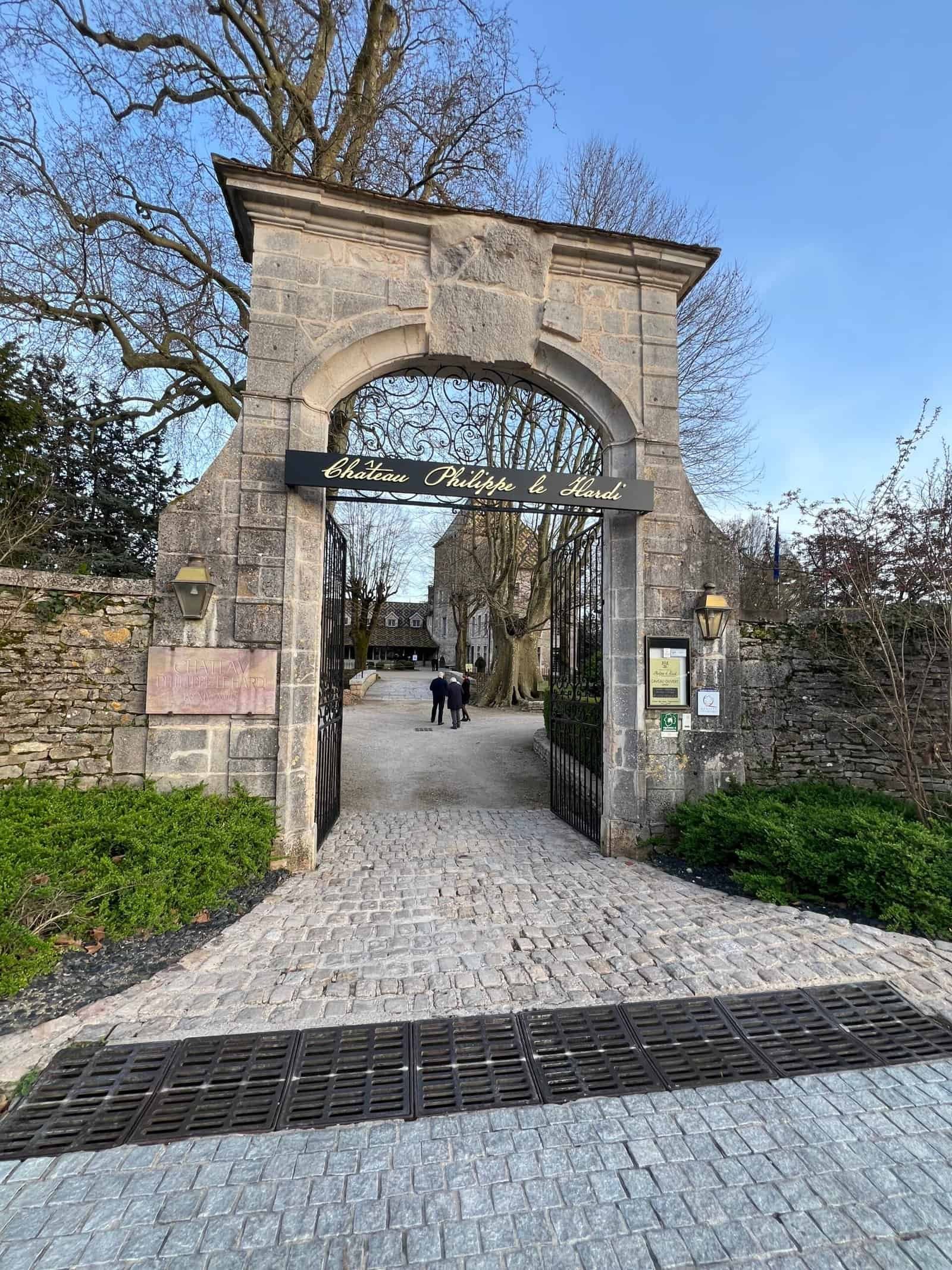 Historic stone entrance gate to Château Prieuré le Hameau in Bourgogne.
